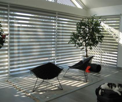 Store intérieur décoratif, permettant, grace à son double-jeu de tissu, de recouvrir partiellement ou totalement les bandes transparentes horizontales.
